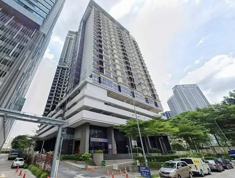 Exterior type: high-rise condominium; features: glass curtain wall, white painted facade, recessed balconies, multiple storeys, surrounded by mature greenery, urban context with nearby buildings, driveway with interlocking pavers; style: modern.