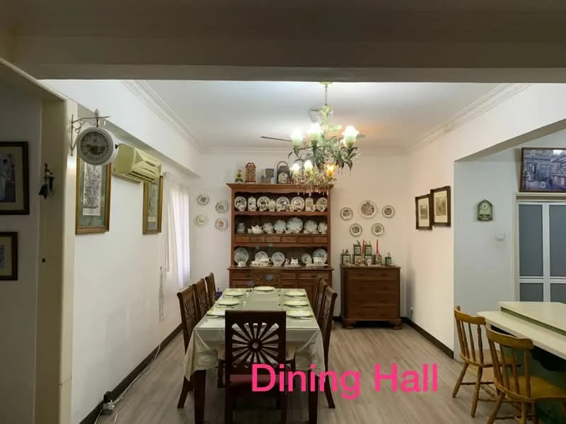 Dining features: wooden dining table with tablecloth, 8 wooden dining chairs, chandelier with multiple bulbs, cream painted walls, laminate flooring, wooden sideboard with decorative plates, wall-mounted air conditioning unit, framed artwork on walls, window with sheer curtains; style: traditional.