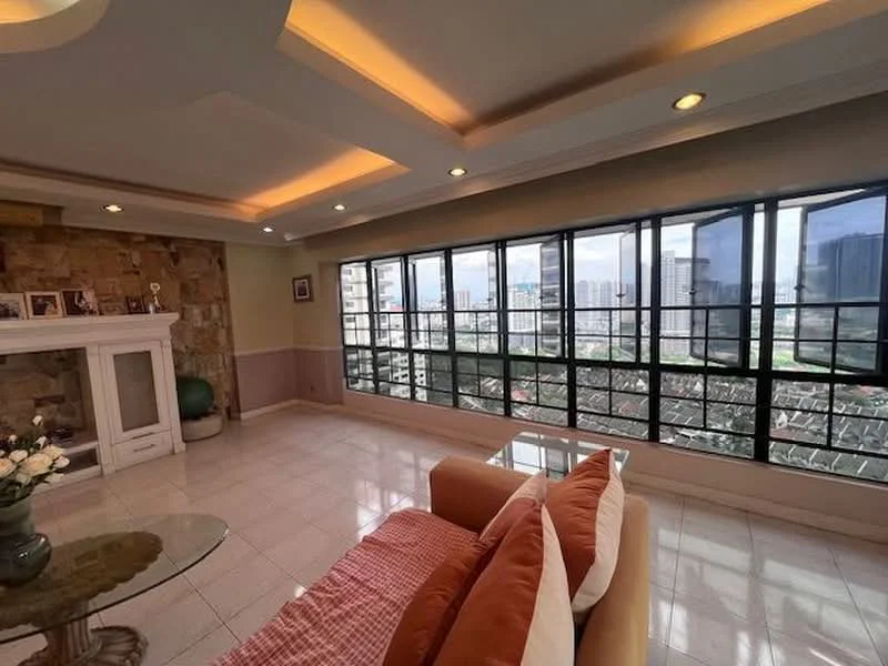 Living features: large floor-to-ceiling windows, white painted walls, tray ceiling with recessed lighting, cream-colored sofa with orange throw pillows, glass coffee table, stone accent wall, tile flooring, decorative fireplace, city view through windows; style: contemporary; view: city.