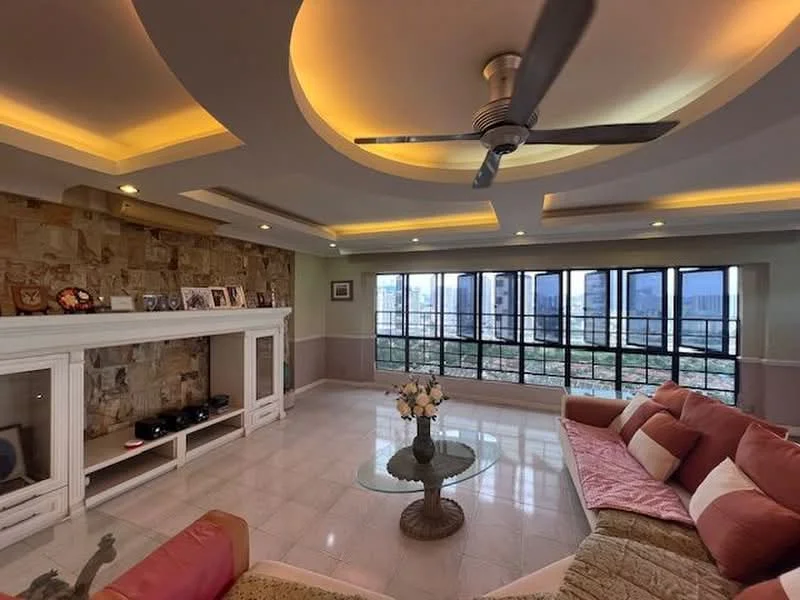 Living features: tray ceiling with recessed lighting, 5-blade ceiling fan, large floor-to-ceiling windows, stone accent wall, white painted walls, glossy tile flooring, glass coffee table, sectional sofa in pink and beige, TV console, decorative vases, framed photographs on shelf; style: modern; view: city.