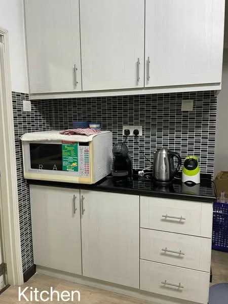 Kitchen features: black countertop, white cabinetry with textured finish, microwave, electric kettle, coffee machine, black and white mosaic tile backsplash, two electrical outlets, drawer storage, cabinet storage; style: modern.