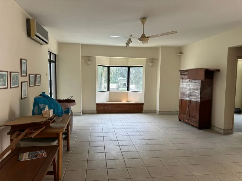 Living features: cream painted walls, tile flooring, ceiling fan, large bay windows, wooden cabinet, built-in bench seating, wall-mounted air conditioning unit, framed artwork on walls; view: garden.
