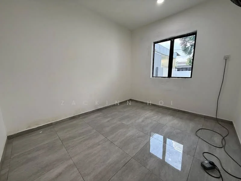 Room features: white painted walls, grey ceramic tile flooring, single window, power outlet, no visible furniture, clean and empty space, natural light from window.