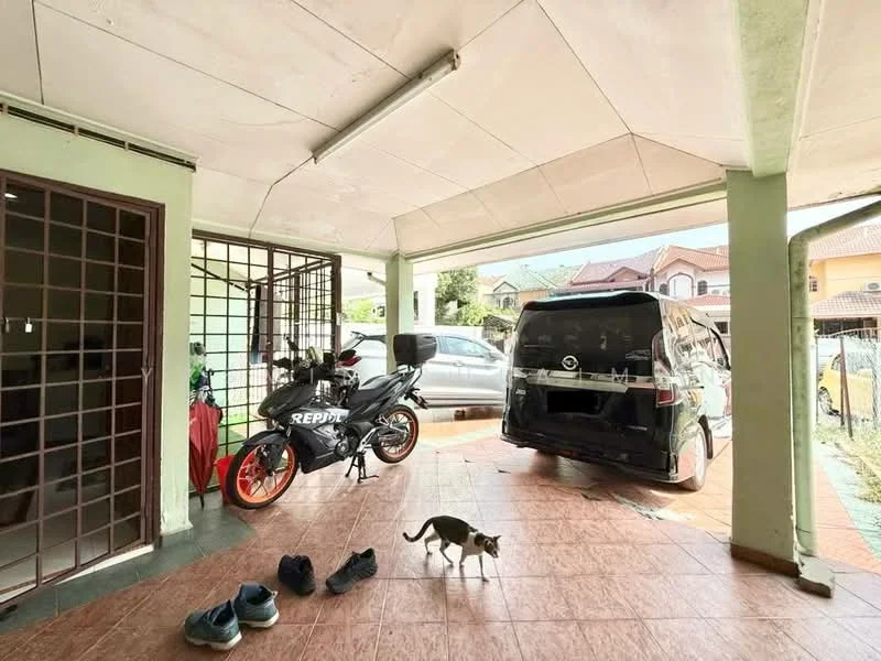 Exterior type: car porch; features: covered car porch, tiled flooring, green painted walls, metal gate, motorcycle parked, van parked, shoes on the floor, cat walking, natural light from overhead, open space; style: modern.