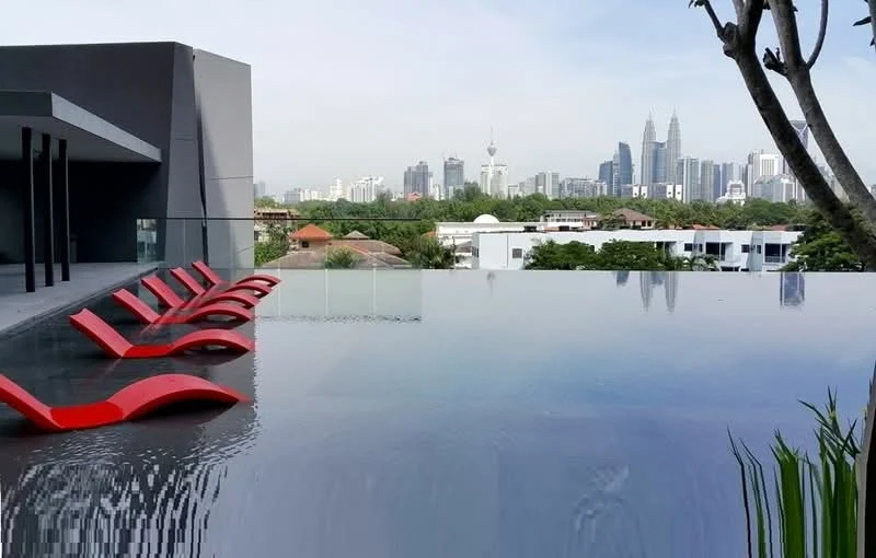 Exterior type: high-rise condominium; features: infinity pool, pool deck with loungers, glass railing, city skyline view, surrounded by greenery, modern architectural design; style: modern.