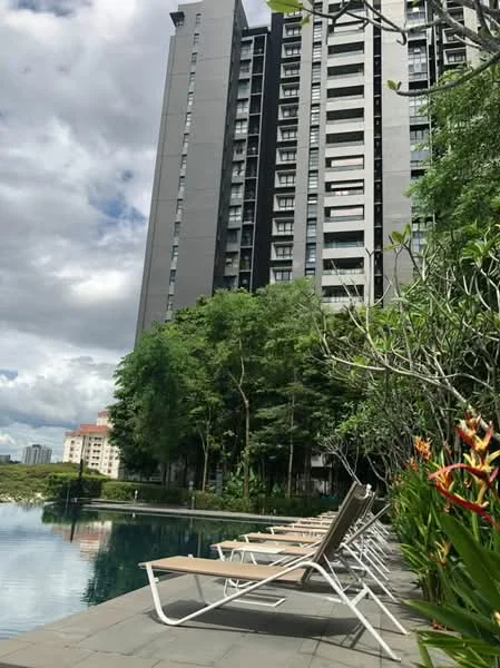 Exterior type: high-rise condominium; features: glass curtain wall facade, approximately 20-storey high-rise, infinity pool, pool deck with loungers, manicured landscaping, mature trees, tropical landscaping, surrounded by greenery; style: modern.