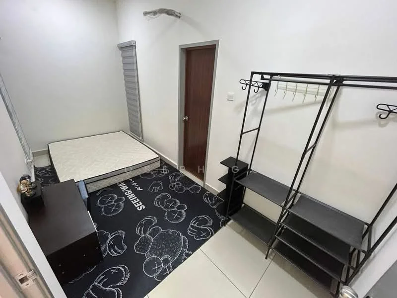 Bedroom features: white painted walls, tile flooring, single mattress on bed frame, black metal clothing rack, black storage cabinet, roller blinds on window, decorative area rug with floral pattern, door with wood finish.