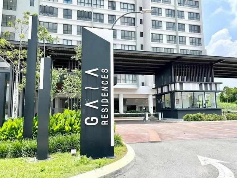 Exterior type: high-rise condominium; features: modern facade with glass and concrete, landscaped garden with greenery, signage with 'GAIA RESIDENCES', paved driveway, entrance with covered walkway, multiple storeys visible, surrounded by manicured lawn; style: modern.
