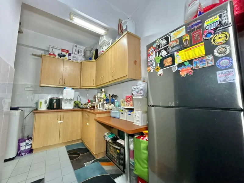 Kitchen features: wood cabinetry, black refrigerator with stickers, white countertop, stainless-steel sink, chrome faucet, kitchen appliances including kettle and toaster, tile flooring, wall-mounted shelves, various kitchen utensils and containers, under-sink storage, colorful storage bins, overhead lighting; style: modern.