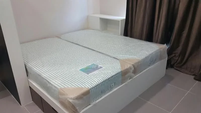 Bedroom features: queen-size bed, mattress with protective cover, white bed frame, built-in bedside shelf, dark brown curtains, grey tiled flooring, wall-mounted storage, neutral wall color; style: modern.