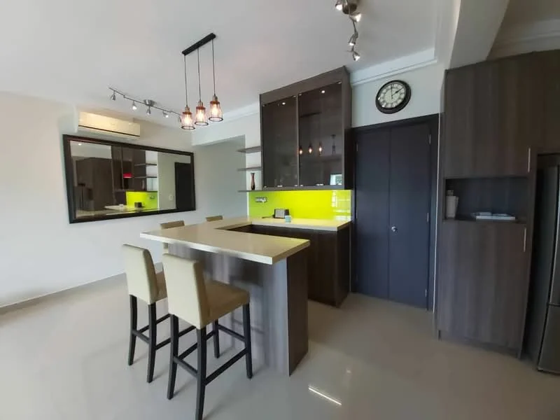 Kitchen features: island countertop with bar seating for 2, stainless-steel sink, chrome pull-down faucet, black cabinetry with glass-front upper cabinets, green backsplash, built-in oven, freestanding fridge, pendant lighting above island, recessed downlights, mirror wall, grey tiled flooring, wall-mounted clock; style: modern.