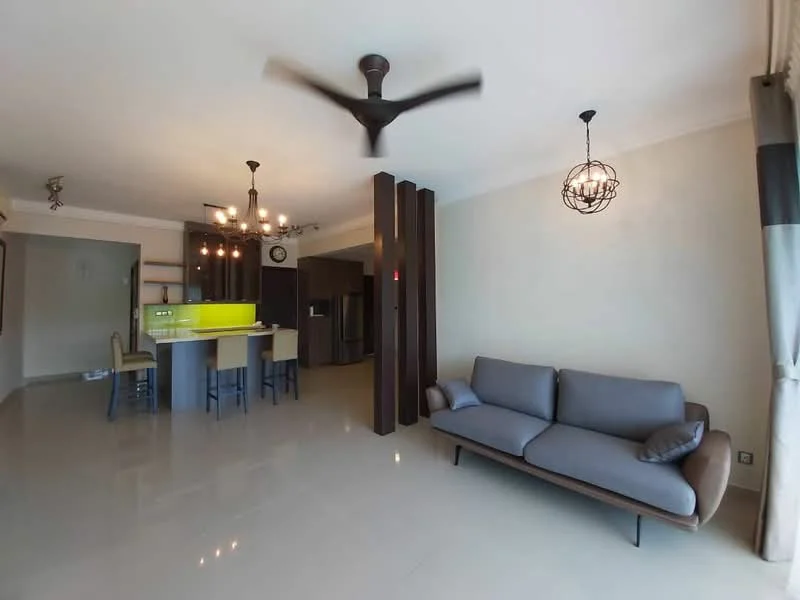 Living features: 3-seater fabric sofa in grey, ceiling fan with integrated light, pendant lighting, wall-mounted TV, glossy tile flooring, neutral painted walls, large windows with curtains, decorative wall paneling; style: modern. Kitchen features: kitchen island with bar seating, green backsplash, built-in cabinets, stainless-steel refrigerator, freestanding range oven, microwave, pendant lights over island, open layout; style: modern.