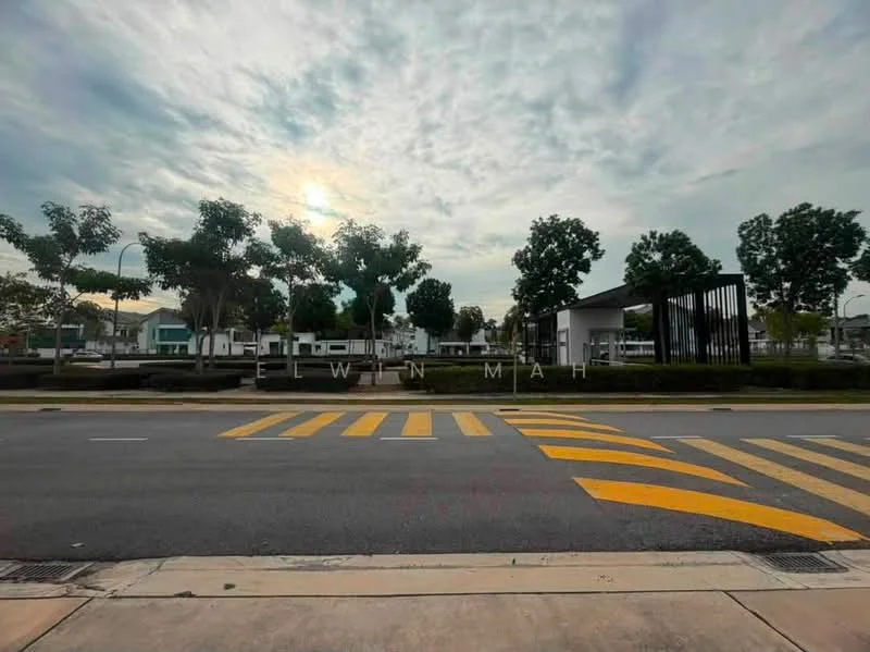 Exterior features: tree-lined street, manicured landscaping, paved sidewalk, road markings, street lamps, residential buildings in background, cloudy sky, sunset lighting; style: modern.