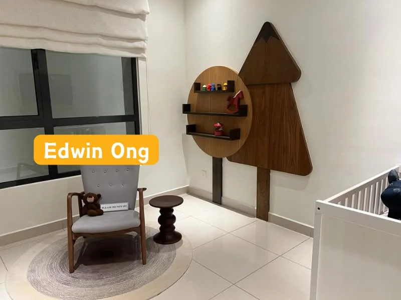 Room features: white painted walls, tile flooring, large window with sheer curtains, round area rug, wooden wall shelf, decorative wooden tree shape on wall, upholstered armchair in grey, small round side table, stuffed toy on chair; style: modern.