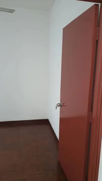 Room features: red door, white painted walls, brown parquet flooring.