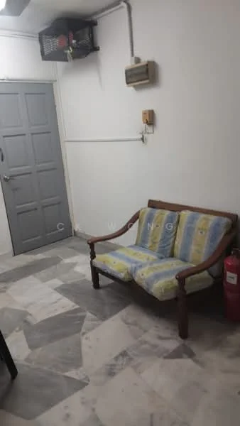 Room features: sofa with blue and yellow upholstery, marble flooring, white painted walls, grey door, wall-mounted air conditioning unit, fire extinguisher, light switch, electrical outlet; style: minimalist.