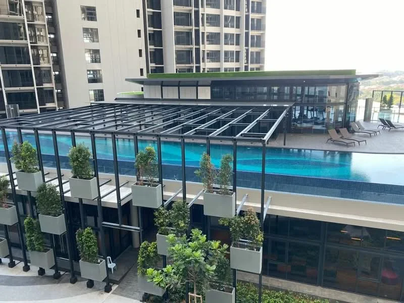 Exterior type: high-rise condominium; features: infinity pool, pool deck with loungers, glass curtain wall, green roof, landscaped terrace with planters, surrounding high-rise buildings, outdoor seating area; style: modern.