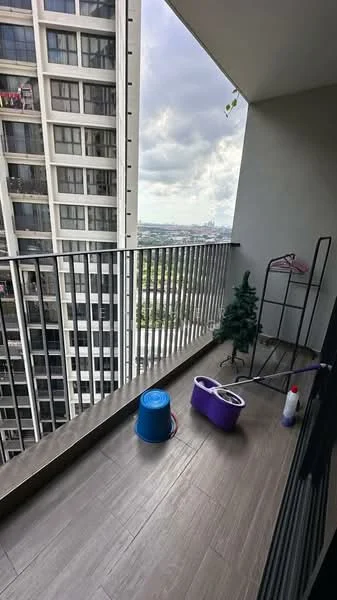 Balcony features: floor-to-ceiling sliding glass door, metal railing, wood-look tile flooring, decorative potted plant, cleaning supplies, bucket, mop, city view; style: modern; view: city.
