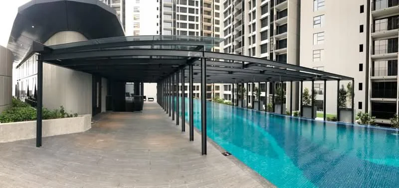 Exterior type: high-rise condominium; features: infinity pool, pool deck with loungers, covered seating area, landscaped garden, glass railing, modern architectural design; style: modern.