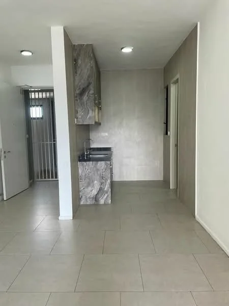 Room features: grey tiled flooring, white painted walls, kitchenette with grey marble countertop, single-bowl stainless-steel sink, wall-mounted cabinet, recessed downlights, door leading to hallway, window with no visible treatment, open layout; style: modern.