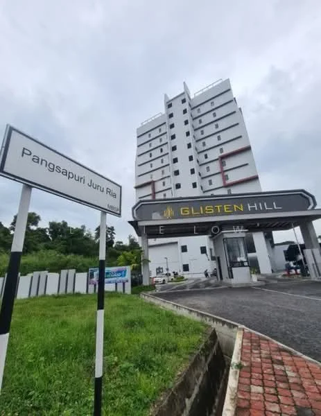Exterior type: high-rise condominium; features: white painted facade, red accent panels, multiple storeys, main entrance gate, signage with building name, paved driveway, landscaped area, surrounding greenery; style: modern.