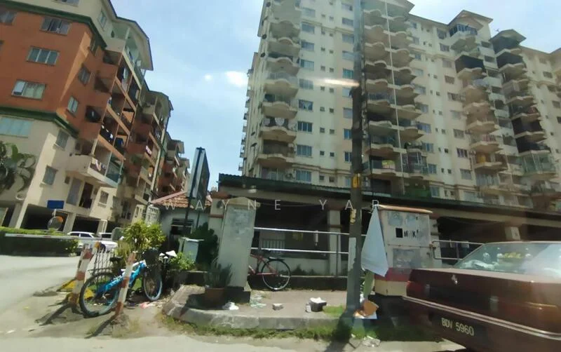 Exterior type: mid-rise condominium; features: cream painted facade, balconies with railings, multiple storeys, surrounded by greenery, parking area visible, bicycle parked outside, street view, sidewalk with plants; style: modern.