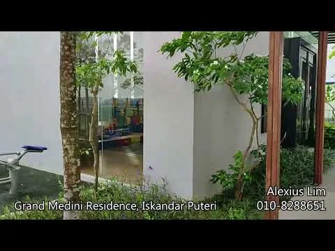 Exterior type: low-rise apartment block; features: white painted facade, large glass windows, manicured landscaping, tropical greenery, playground visible in background, concrete pathway, metal railing, outdoor seating area; style: modern.