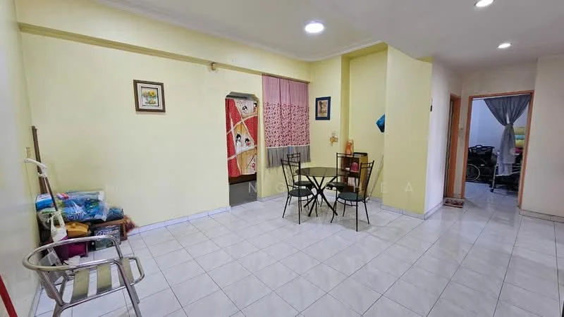 Room features: light yellow painted walls, white tiled flooring, recessed ceiling lights, dining table with four black chairs, framed artwork on wall, curtains with floral pattern, open space layout, storage area with colorful items, doorway leading to another room; style: modern.