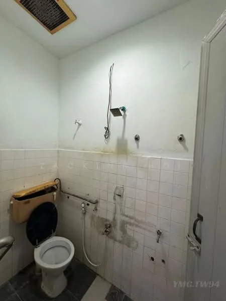 Bathroom features: white tiled walls, grey floor tiles, one-piece toilet, wall-mounted sink, grab bars, exposed plumbing, shower fixture, light fixture, ventilation grill.