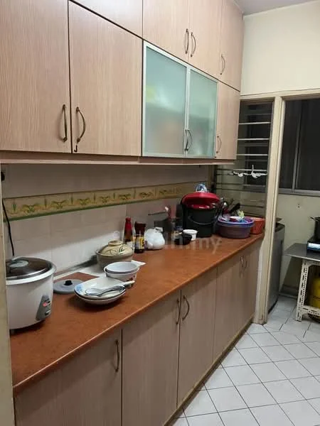 Kitchen features: laminate cabinetry in light wood finish, countertop in brown laminate, ceramic tile flooring, built-in rice cooker, various bowls and utensils on countertop, window with metal grille, wall-mounted shelves, decorative tile backsplash, sink with faucet, appliances including a stove, kitchen items on countertop.