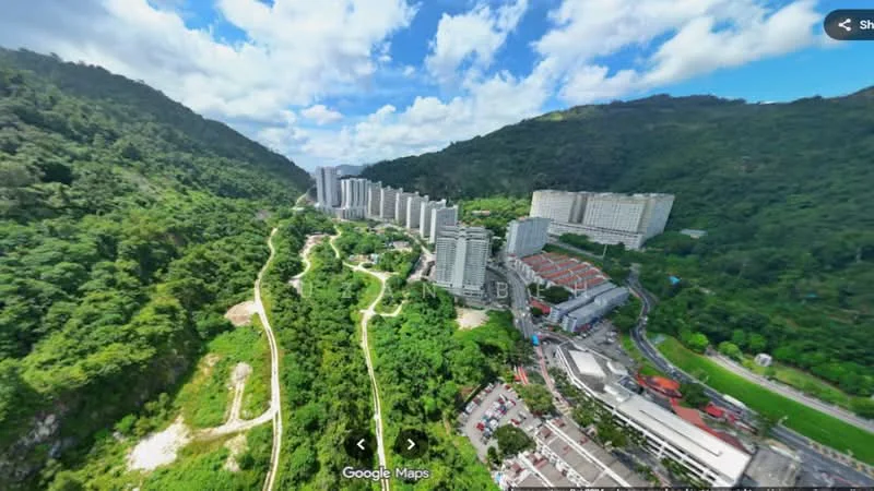 Exterior type: high-rise condominium; features: multiple high-rise buildings, surrounded by greenery, mountain backdrop, urban landscape, parking area visible, road access, manicured landscaping; style: modern.