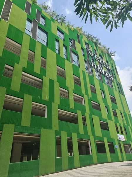 Exterior features: green facade with vertical patterns, multiple levels visible, large windows, landscaping on upper levels, open-air parking area, modern architectural design; style: modern.