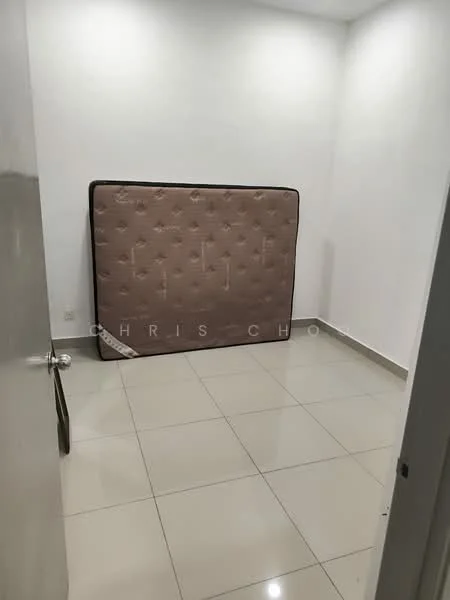 Room features: white painted walls, glossy tile flooring, single mattress propped against wall, door, light switch, corner baseboard.