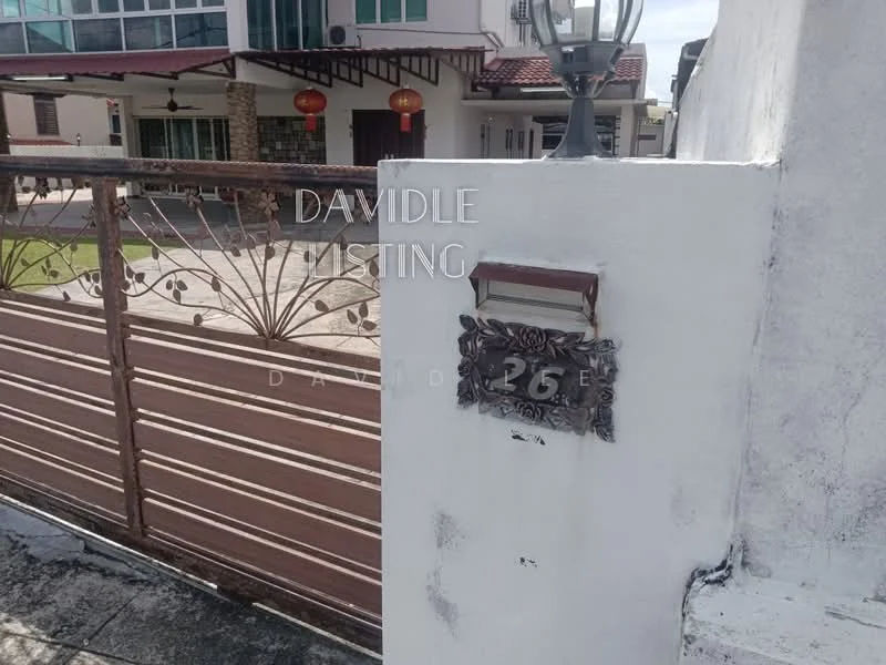Exterior type: linked terrace house; features: metal gate with decorative design, number plaque with the number 26, white painted wall, brick facade visible in background, outdoor lantern, manicured lawn in background; style: modern.