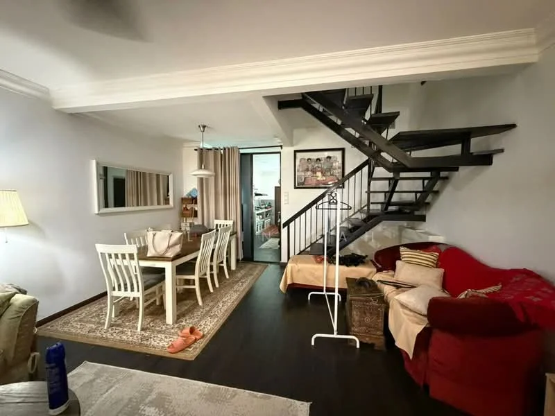 Living features: dark wood flooring, white painted walls, crown moulding, sofa in red fabric, coffee table, area rug with geometric pattern, floor lamp, wall-mounted mirror, decorative artwork, open staircase with dark wood railing; style: modern. Dining features: 6-seater dining table, white wooden dining chairs, pendant light above dining table, sideboard against wall, decorative items on sideboard; style: modern.