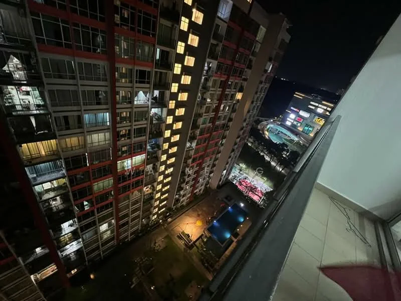 Exterior type: high-rise condominium; features: night view of building facade, balconies visible on multiple floors, landscaped garden area, swimming pool visible, outdoor seating area, lighting along pathways, surrounding buildings in view; style: modern.