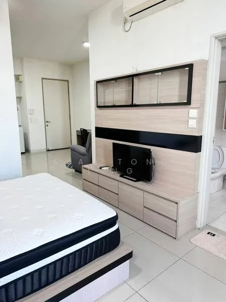 Room features: queen-size bed, mattress on bed frame, wall-mounted TV, wooden TV console, light-colored wall panels, black accent strip on wall, air conditioning unit, tile flooring, window with natural light, grey armchair, built-in wardrobe, door leading to bathroom, neutral color scheme; style: modern.