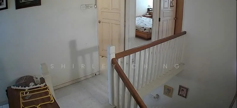 Room features: white painted walls, light-colored flooring, wooden handrail, staircase, doorway leading to another room, decorative wall art, framed pictures on wall.