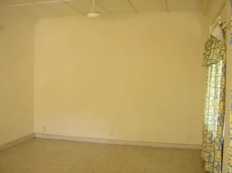 Room features: plain white walls, light-colored flooring, ceiling fan, curtains with floral pattern, large window, no visible furniture; style: minimalist.