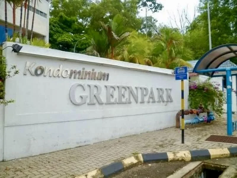 Exterior type: condominium; features: white painted facade, signage with the name 'GREENPARK', landscaped greenery, paved walkway, surrounding palm trees, entrance gate structure; style: modern.