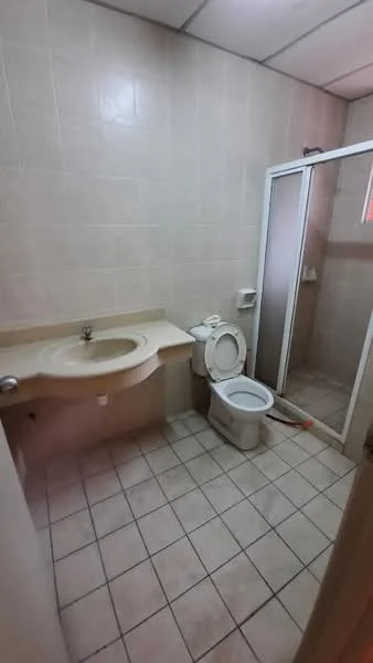 Bathroom features: cream tiled walls, beige tiled flooring, single-sink vanity with countertop, toilet, walk-in shower with glass enclosure, shower head, mirror above vanity, towel rack.