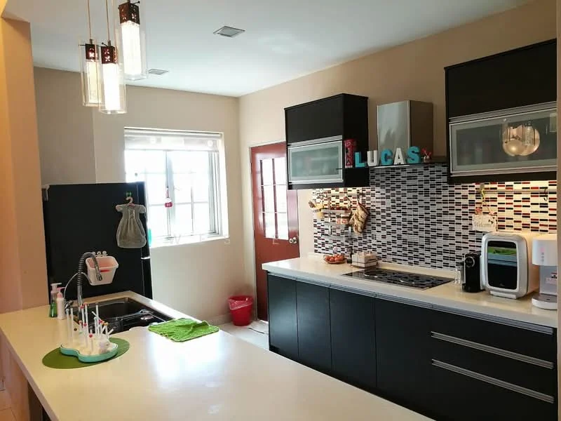 Kitchen features: black cabinetry with flat-panel doors, white countertop, stainless-steel sink, chrome pull-down faucet, built-in gas hob, built-in oven, microwave, colorful mosaic tile backsplash, window with sheer curtains, door with glass panels, kitchen island, decorative items on countertop, green dish towel, red waste bin; style: modern.