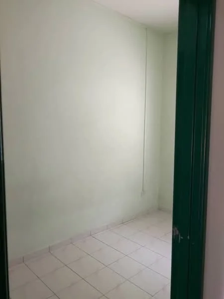 Room features: light green painted walls, white tiled flooring, single light fixture, no visible windows, empty space.