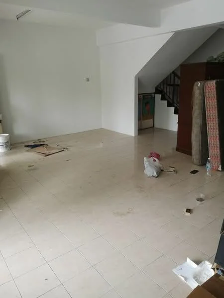 Room features: white painted walls, tile flooring, staircase, empty space, visible debris, unfurnished, corner with furniture, natural light from window.