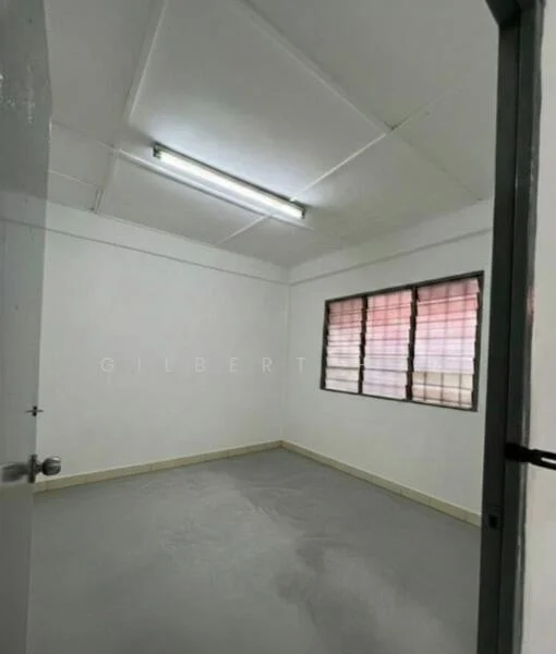 Room features: white painted walls, grey flooring, fluorescent ceiling lights, single window with metal frame, window with red and white grid pattern, plain ceiling, no visible furniture; style: minimalist.