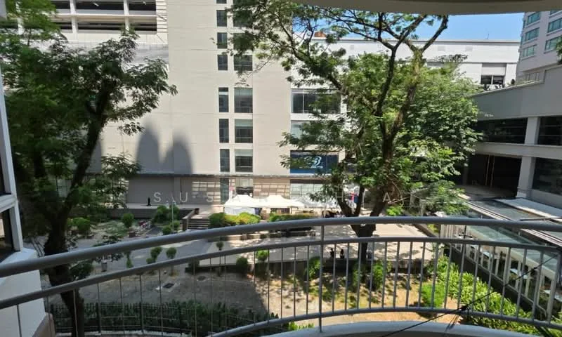 Room features: balcony with railing, view of landscaped garden, view of outdoor dining area, surrounding trees, sunlight filtering through trees, paved walkway, seating area with umbrellas; view: garden.