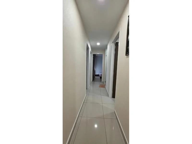Hallway features: white painted walls, glossy ceramic tile flooring, recessed downlights, door frames, neutral color scheme, wide corridor, no visible decor, smooth ceiling; style: modern.