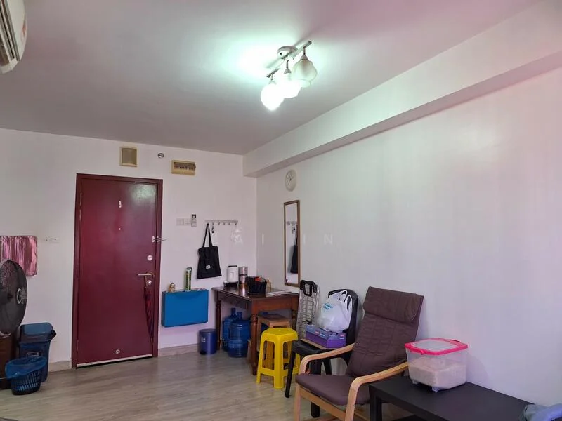 Living features: laminate flooring, white painted walls, recessed ceiling lights, wall-mounted air conditioning unit, brown wooden door, brown wooden table, black fabric armchair, plastic storage containers, blue plastic basket, water dispenser, wall clock.