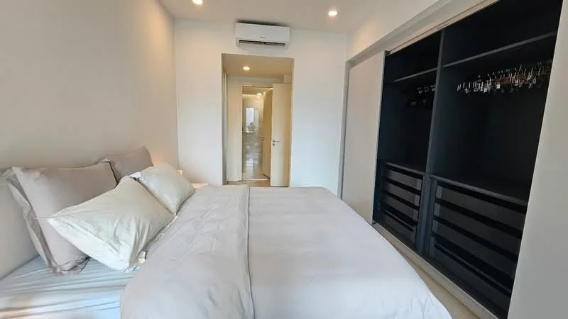 Bedroom features: king-size bed with white bedding, upholstered headboard, built-in wardrobe with sliding doors, wall-mounted air conditioning unit, recessed ceiling lights, neutral painted walls, wooden flooring, doorway leading to bathroom, decorative pillows; style: modern.