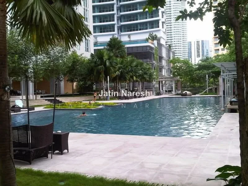 Exterior type: high-rise condominium; features: infinity pool, pool deck with loungers, landscaped garden with tropical plants, manicured lawn, surrounded by palm trees, modern architectural design, outdoor seating area, water features, children's play area; style: modern.